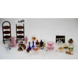 A quantity of dolls house glass cake stands, cakes, drinks bottles, glass decanters, etc.
