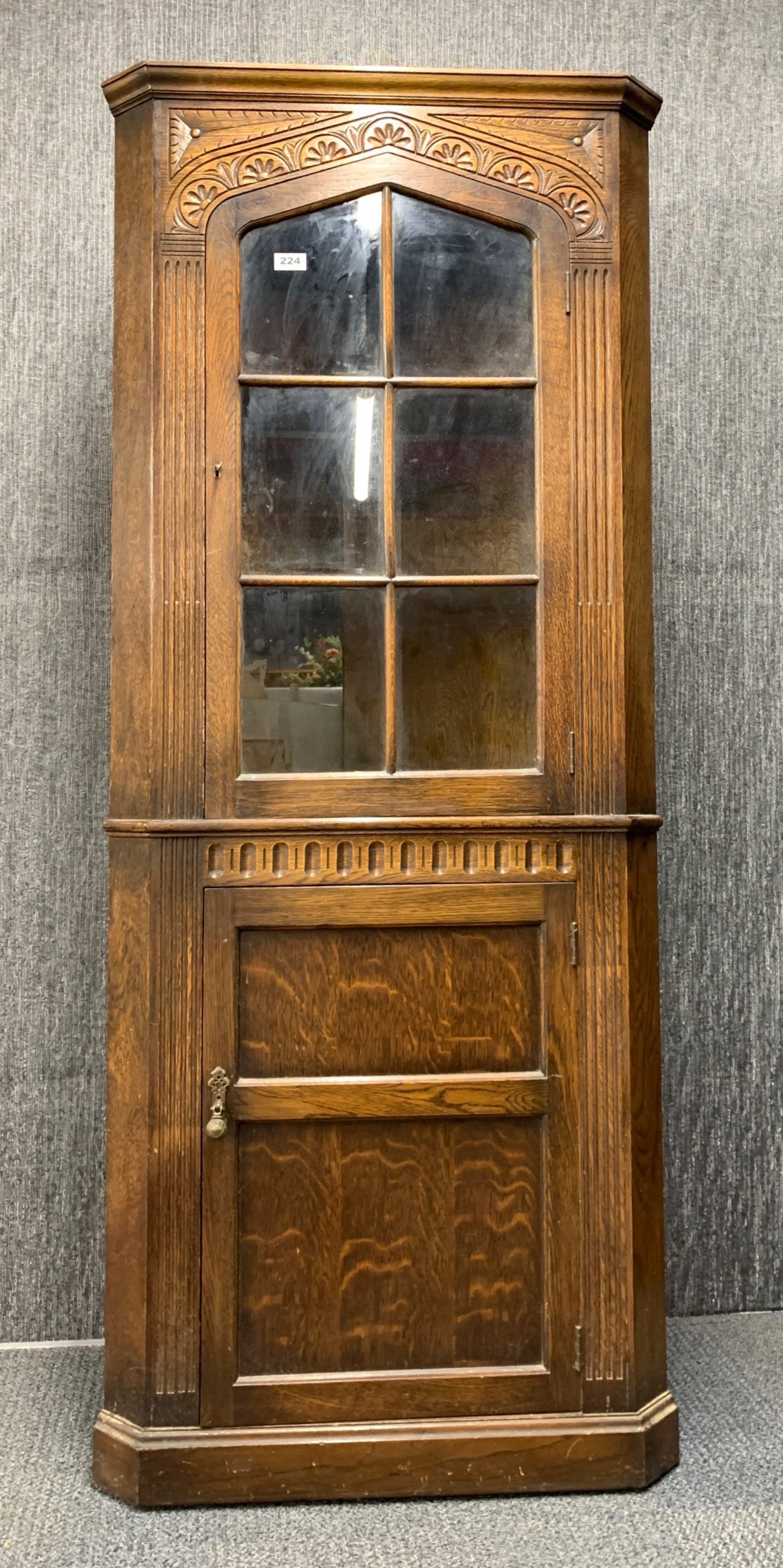 A carved oak corner cabinet, H. 177cm.