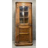 A carved oak corner cabinet, H. 177cm.