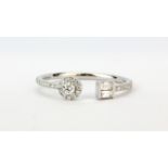 An 18ct white gold adjustable ring set with brilliant and baguette cut diamonds.