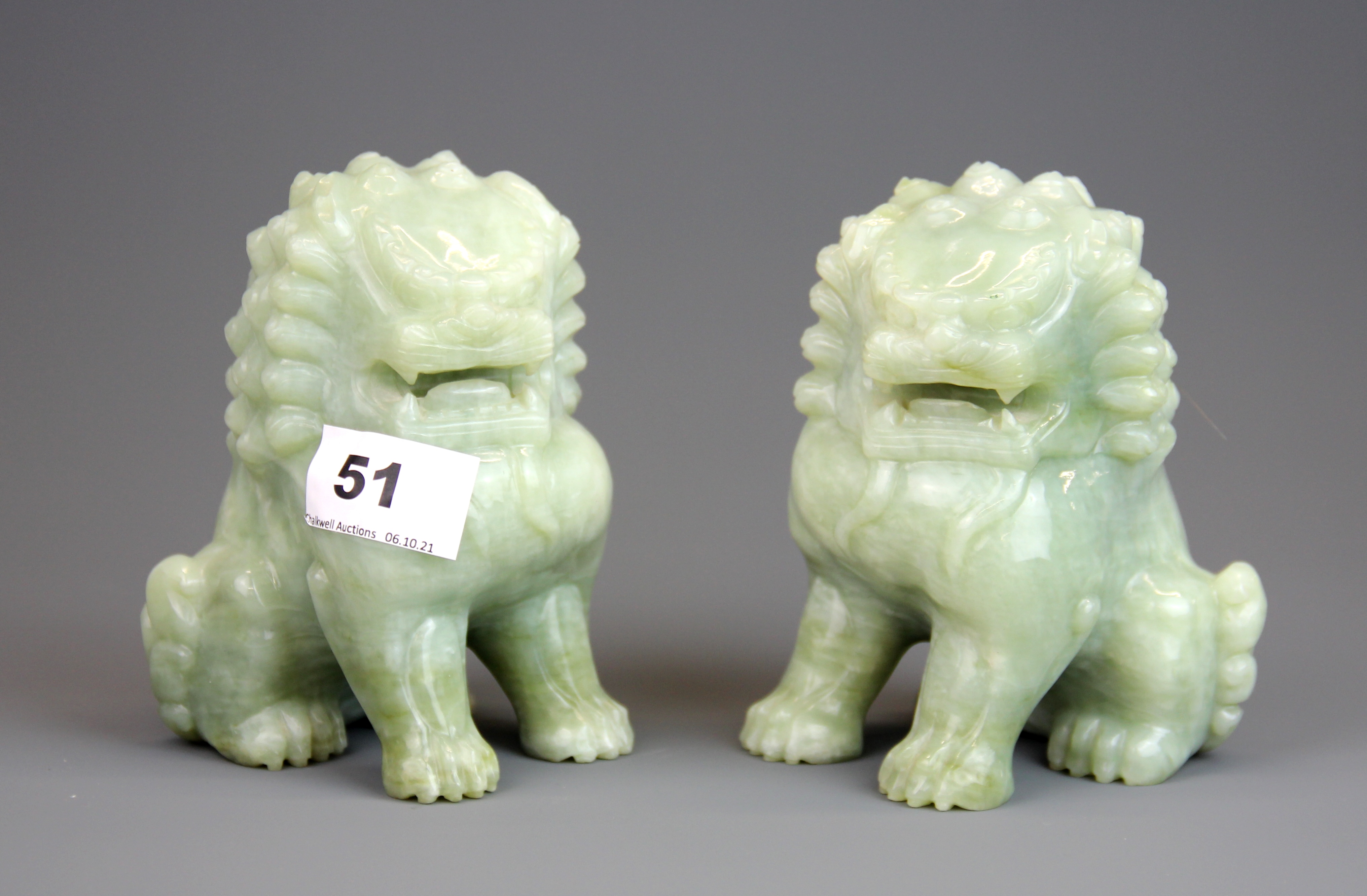 A pair of Chinese carved jade / hardstone figures of lions, H. 13.