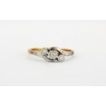 An 18ct yellow gold and platinum diamond set crossover ring, (I).