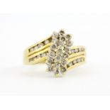 A 18ct yellow gold diamond set cluster ring, (M).