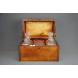A 19th Century walnut veneered tantalus case with four decanters and six glasses. Case size, 30.5
