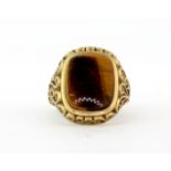 A gentleman's 9ct yellow gold tiger's eye signet ring, (M).