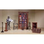A quantity of dolls house furniture, including a bookshelf with a collection of individual books,