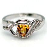 A 925 silver ring set with a trillion cut citrine and white stones, (R.5).