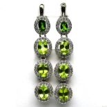 A pair of 925 silveer drop earrings set with peridots surrounded by white stones, L. 4.5cm.