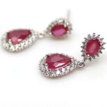 A pair of 925 silver drop earrings set with pear cut rubies surrounded by white stones, L. 2.4cm.