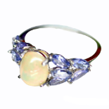 A 925 silver ring set with a cabochon cut opal and tanzanites, (N).