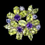 A 925 silver flower shaped ring set with oval cut peridots, tanzanites and amethysts (P).