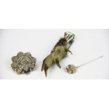 A Victorian silver brooch, silver and gold stick pick and a white metal mounted grouse claw.