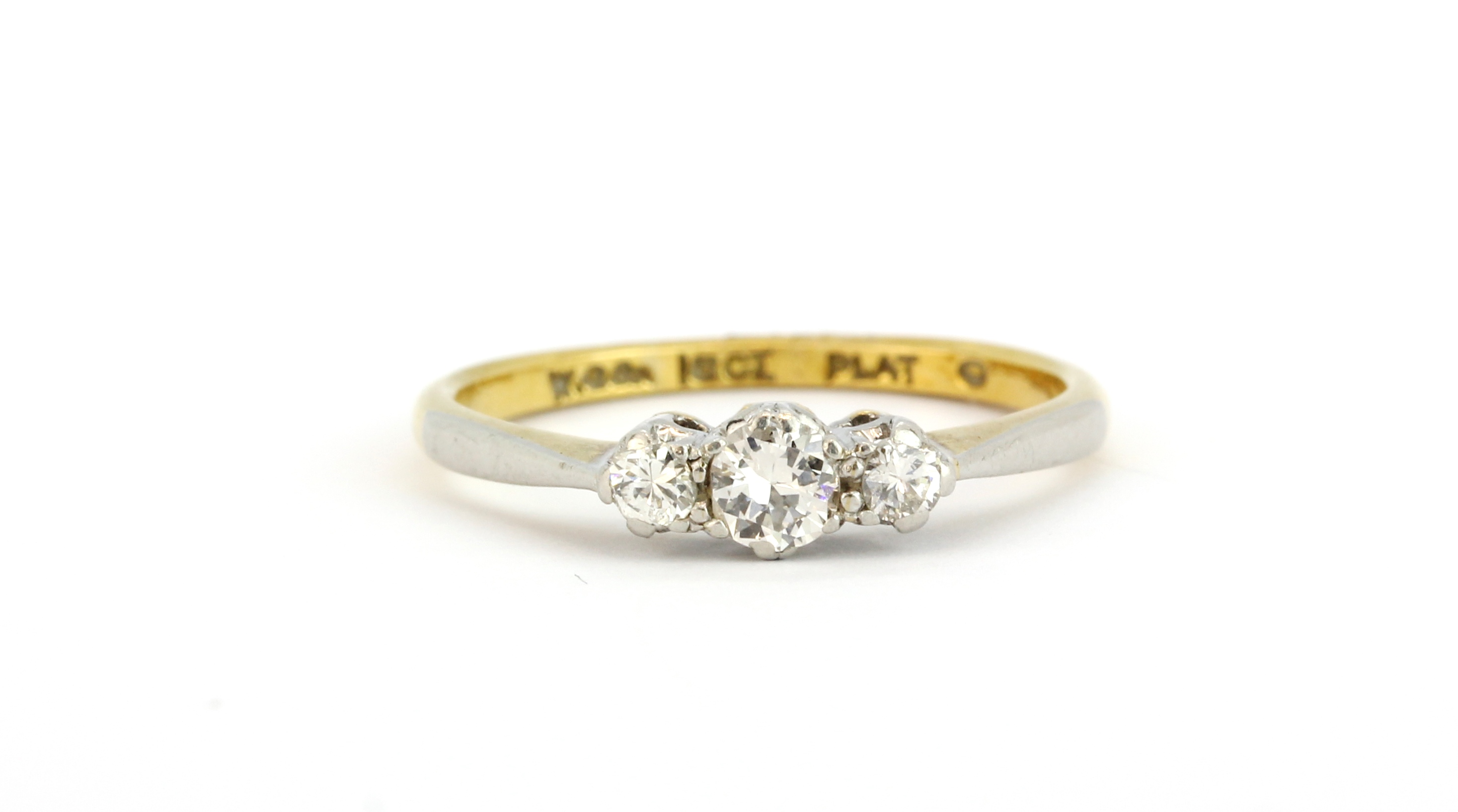 An early 18ct yellow gold and platinum ring set with three brilliant cut diamonds, (L).