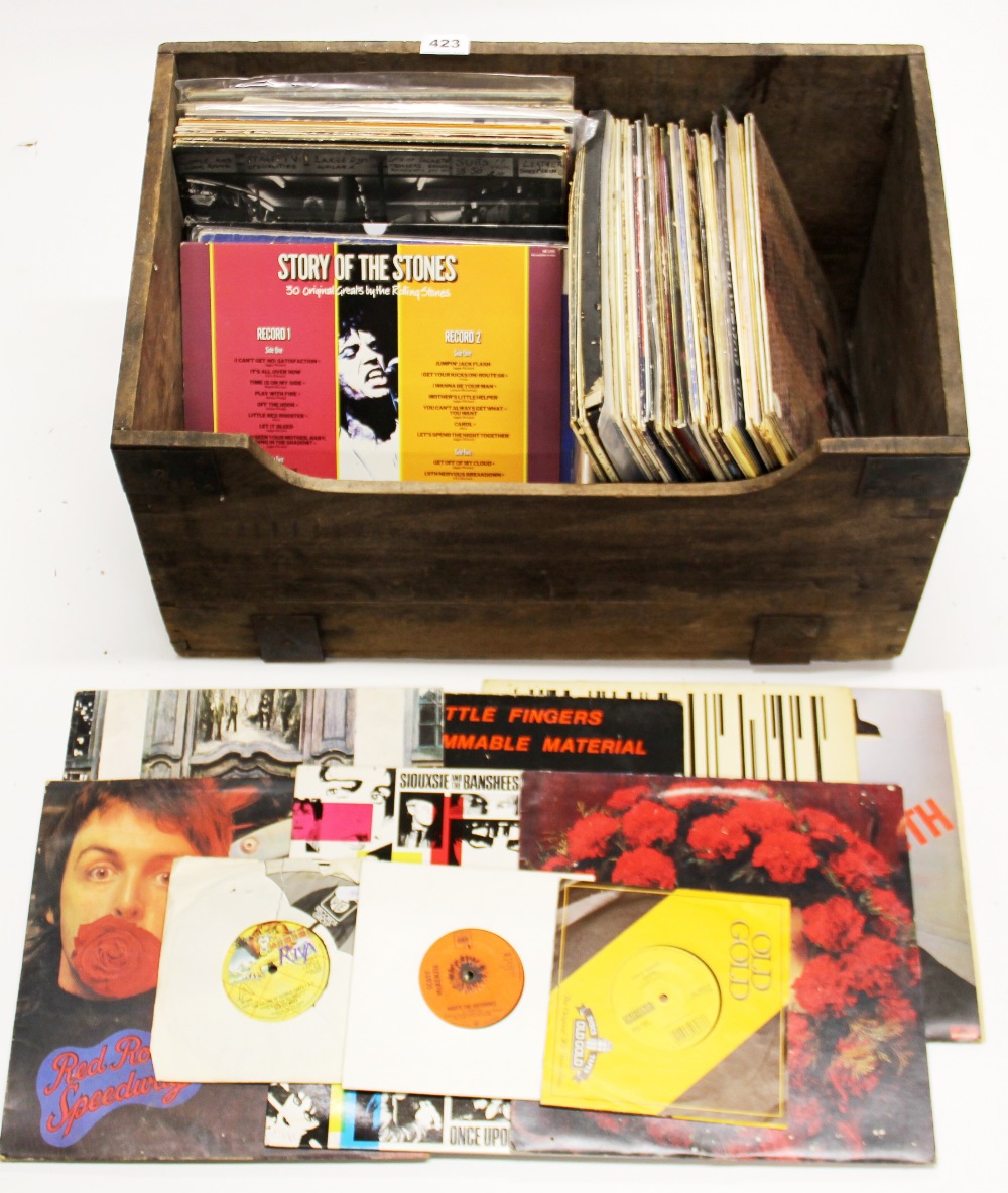 A wooden crate of LP and single records.