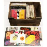 A wooden crate of LP and single records.