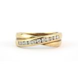 A hallmarked 9ct yellow gold crossover ring set with brilliant cut diamonds, (P.5).