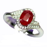 A 925 silver ruby and white stone set crossover ring, (R).