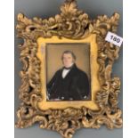 A gilt framed early 19th Century hand painted portrait of a gentleman on what appears to be milk