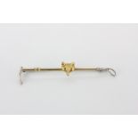 A 9ct gold and silver riding crop brooch, L. 6cm.