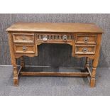 A carved oak desk, H. 73cm. W. 107cm.