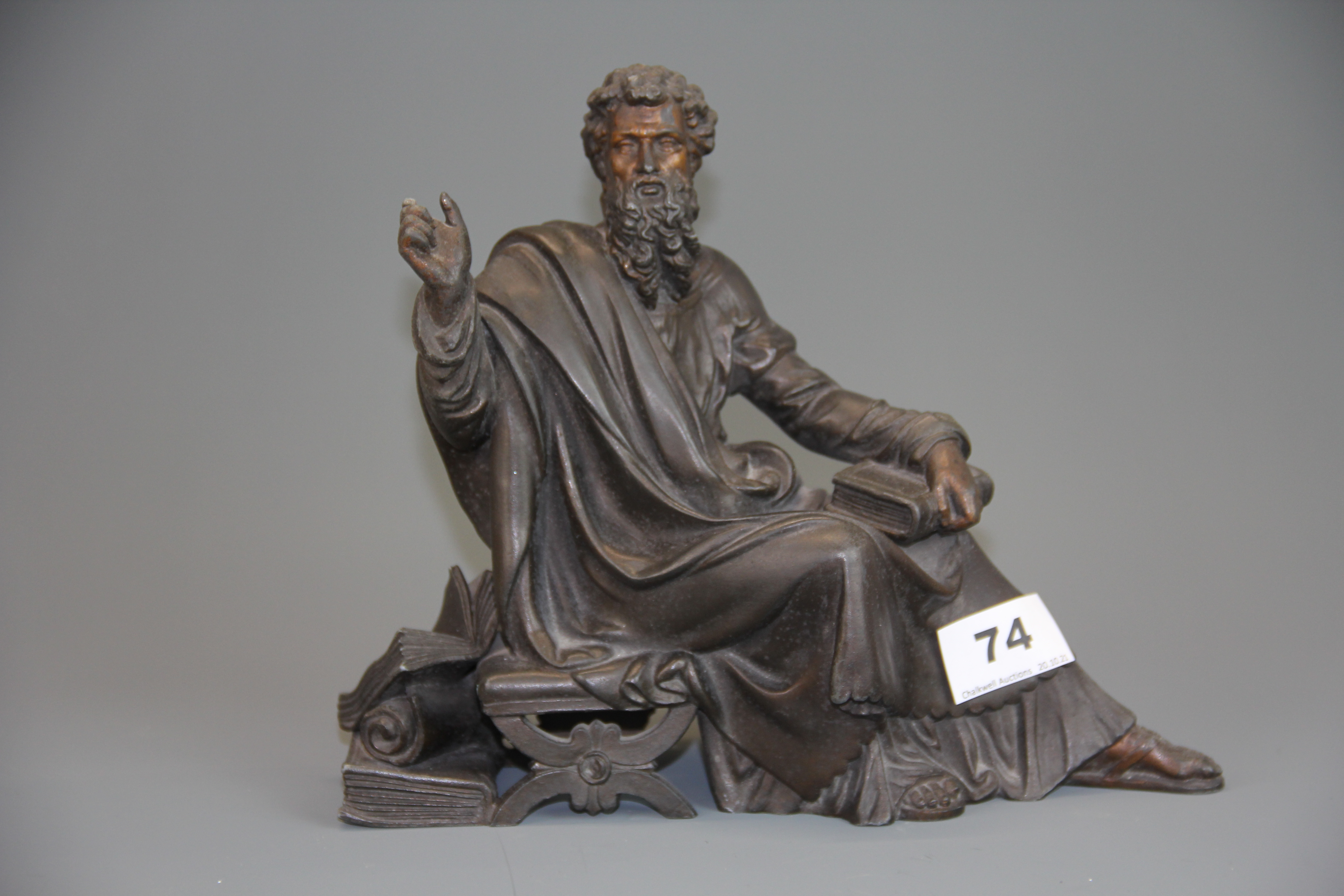 A gilt spelter figure of a bearded gentleman with books, W. 24cm.