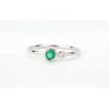 An 18ct white gold emerald and diamond set ring, (P).