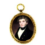 A gilt framed hand painted portrait miniature of a young gentleman with a lock of hair and the