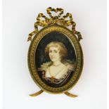 A framed hand painted portrait miniature on ivory of a young woman in Elizabethan style dress, L.