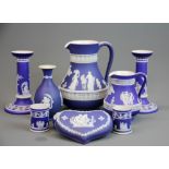 A collection of dark blue Wedgwood jasper ware. Condition: repair to candlesticks.