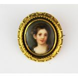 A 19th century yellow metal mounted hand painted porcelain portrait miniature set as a brooch, L.