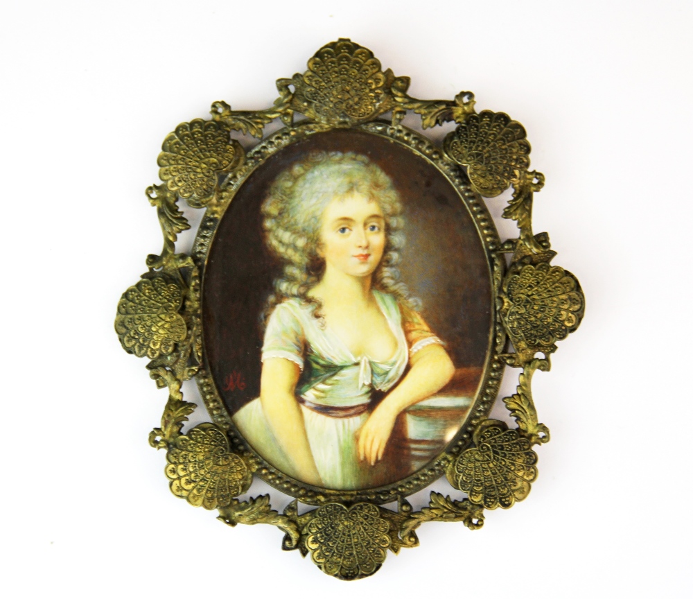 A 19th century hand painted portrait miniature of a young woman initialled M., L. 15cm.