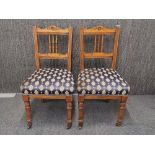 A pair of upholstered Edwardian hall chairs.