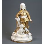 A 19th century French gilt porcelain figure of a young prince with a dog, H. 24.5cm.
