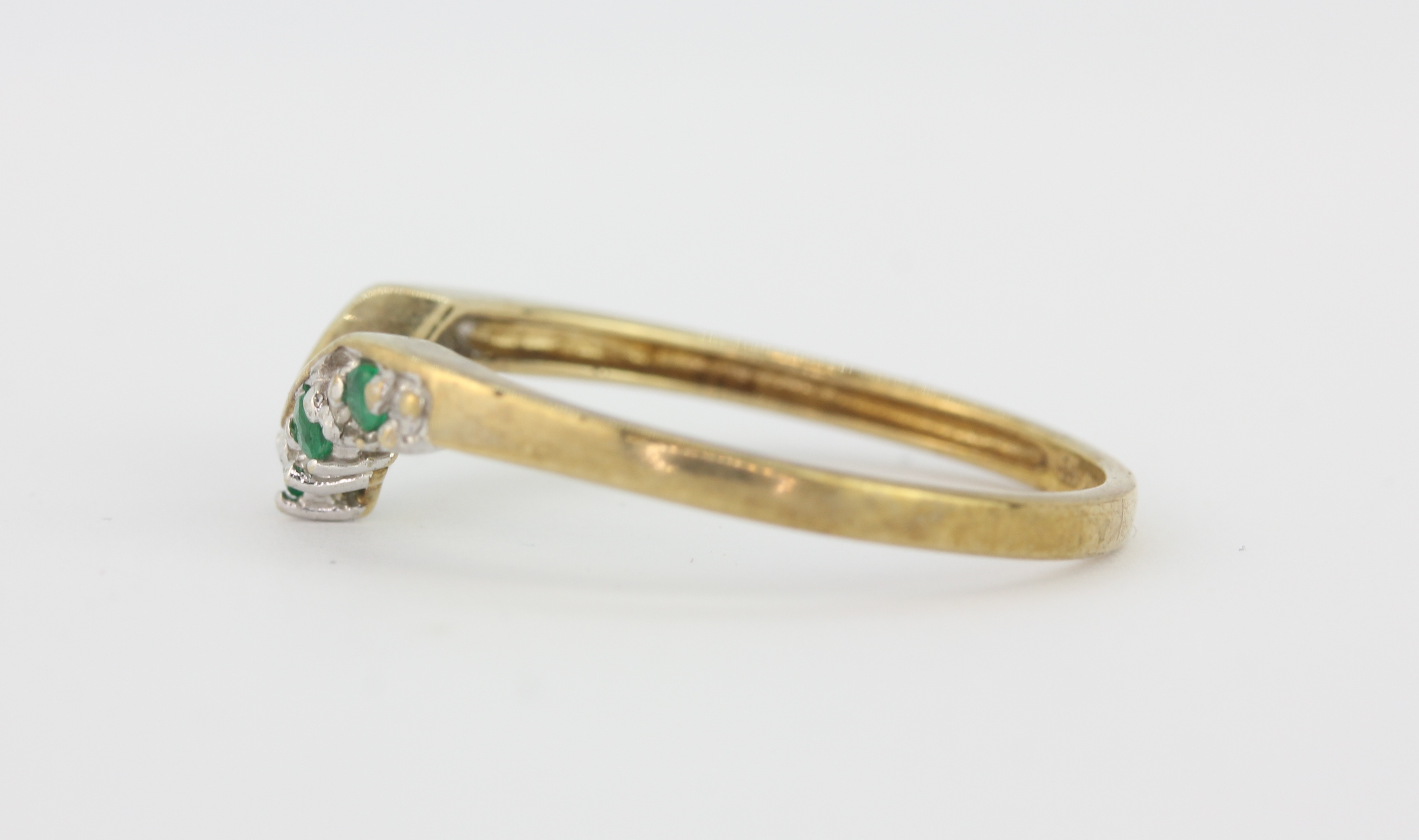 A hallmarked 9ct yellow gold wishbone ring set with round cut emeralds and diamonds, (Q.5). - Image 2 of 2