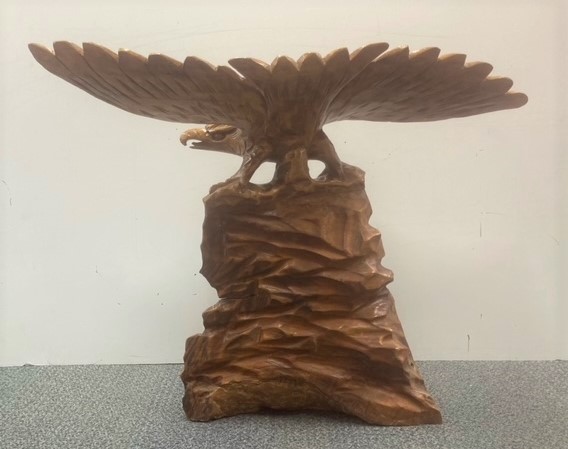 A large carved wooden figure of an eagle on a rock, H. 60cm. Wing span 78cm. - Image 2 of 3