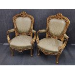 A pair of upholstered gilt carved wood 19th century thrown style arm chairs, A/F. H. 110cm.