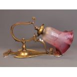 A lovely Art Nouveau brass hanging electric wall lamp and frosted cranberry shade, H. 33cm.