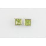 A similar pair of hallmarked 9ct white gold peridot set stud earrings, L. 5mm.