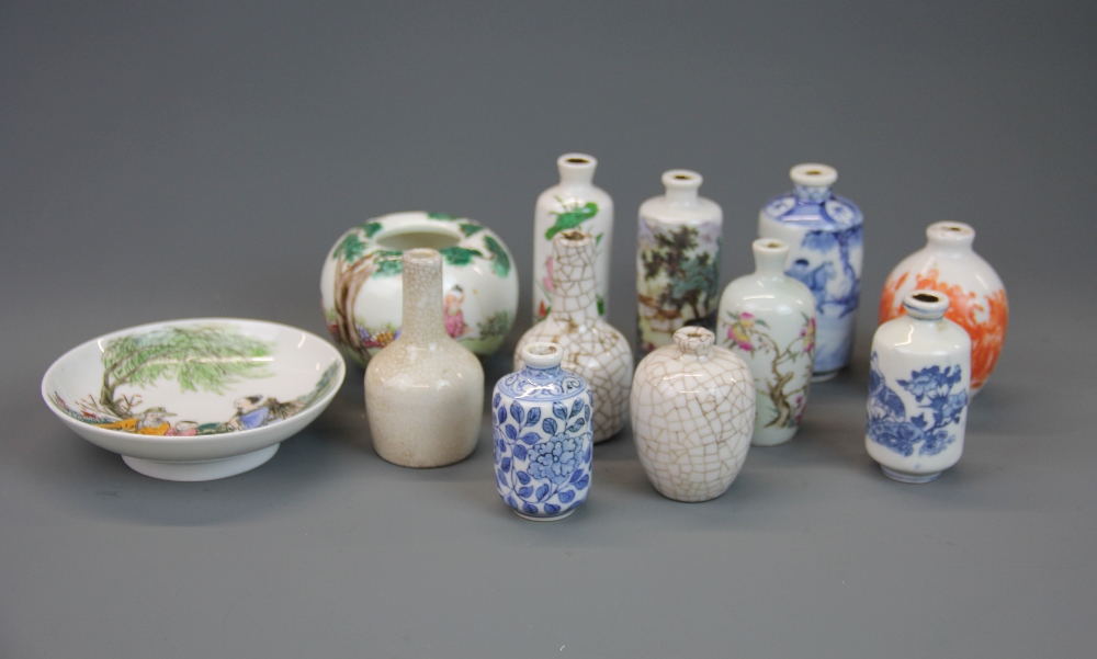 A group of Chinese porcelain snuff bottles with a brush washing bowl and dish.