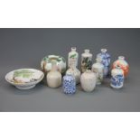 A group of Chinese porcelain snuff bottles with a brush washing bowl and dish.
