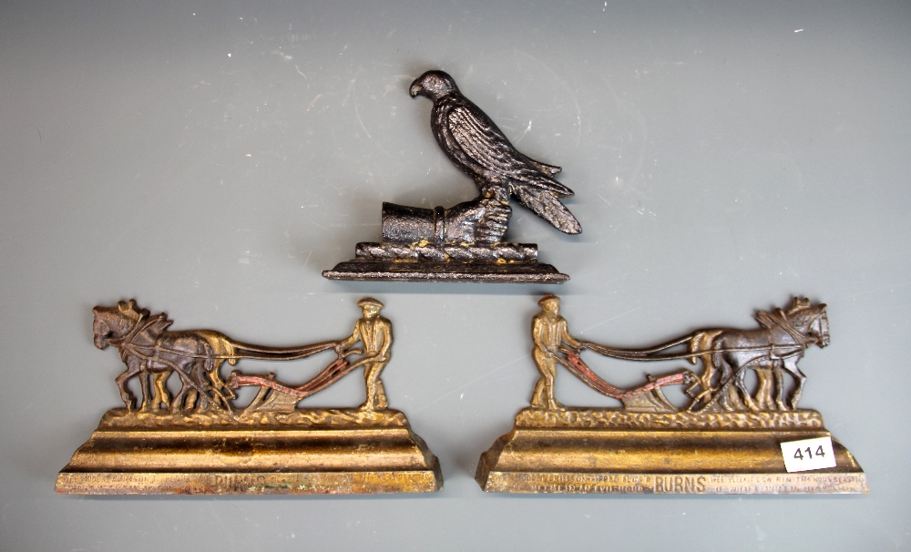 A pair of cold painted metal cast iron ploughing items with a cast iron doorstop, L. 29cm.