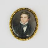 A 18th/ early 19th century hand painted portrait miniature of a young man, L. 5cm.