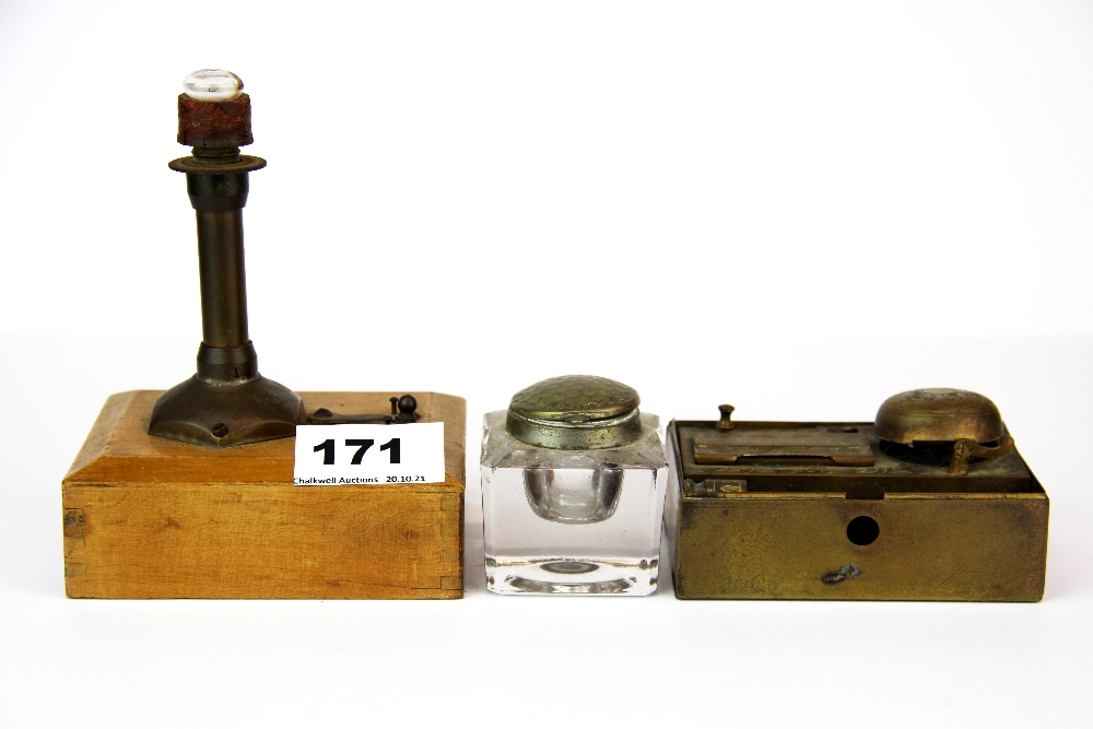 A small early battery operated light house lamp with two inkwells.