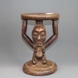 An early 20th century carved African wooden stool, H. 28cm.