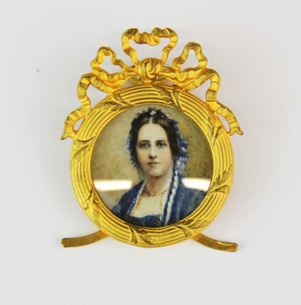 A 19th century gilt framed hand painted portrait miniature of a lady in blue, L. 6cm.