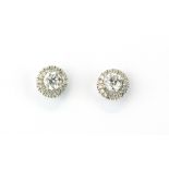 A pair of white metal (tested 18ct gold) halo earrings set with brilliant cut diamonds, L. 8mm,
