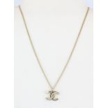 A Chanel necklace with Chanel shaped logo pendant with original box, chain L. 60cm.