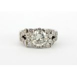 An 18ct white gold cluster ring set with a large brilliant cut diamond, approx. 2.25ct, surrounded