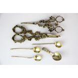 A group of four hallmarked silver spoons and two pairs of silver plated grape scissors.