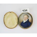 A yellow metal framed hand painted 18th century portrait miniature of a gentleman in a leather